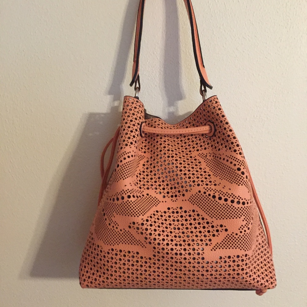 Perforated peach bucket bag